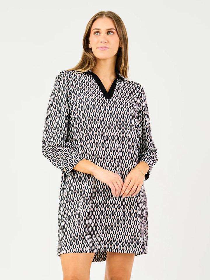 Raelyn High Notes Tan Dress: patterned, long sleeves, black V-neck collar. Available in sizes XS-XL.