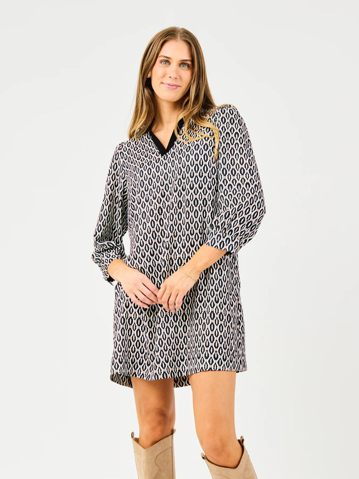 Raelyn High Notes Tan Dress: relaxed fit, long sleeves, black and white geometric pattern. Available in XS–XL.