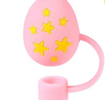 Pink, egg-shaped Easter Straw Cover with looped handle and yellow star decorations; available in multiple sizes.
