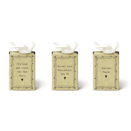 Dove Matchbox set includes three beige, matchbox-style decorative blocks, each with a white dove figurine on top and an uplifting message, accented with hearts. Available in one size.