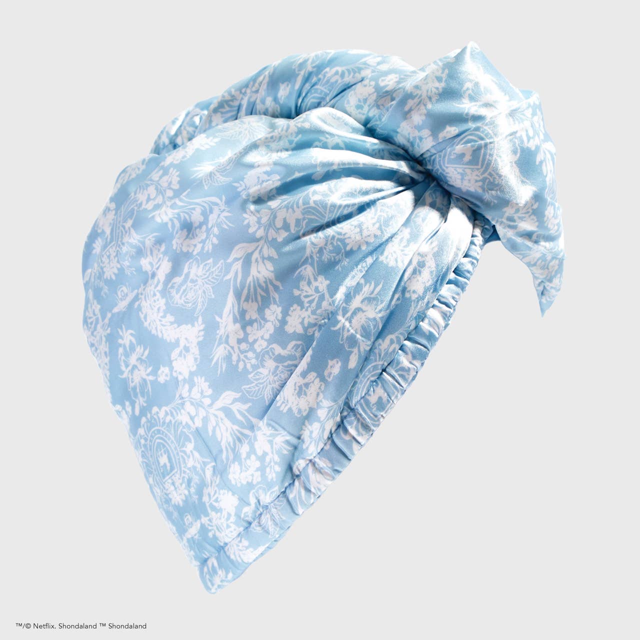 Light blue satin hair towel with white floral pattern, elastic band, front knot. Sizes: One size fits most.