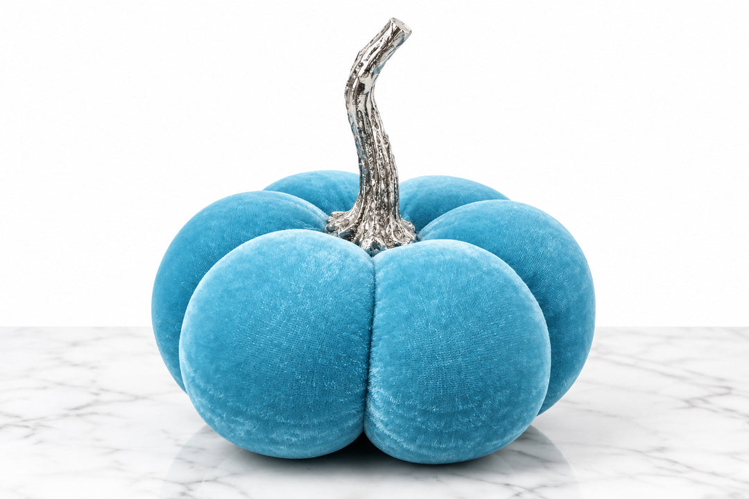 Bright blue velvet pumpkin with a textured brown stem.