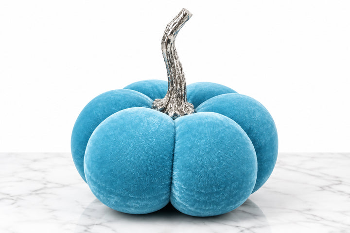 Bright blue velvet pumpkin with a textured brown stem.