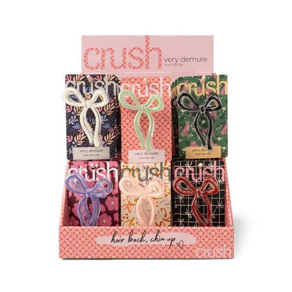 Six Crush Very Demure Bow Hair Clips in pastel and dark shades, available in one size, on patterned cards in a display box.