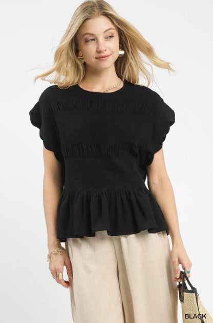Black Smocked Peplum Top with ruffle peplum hem, available in sizes XS-XL.