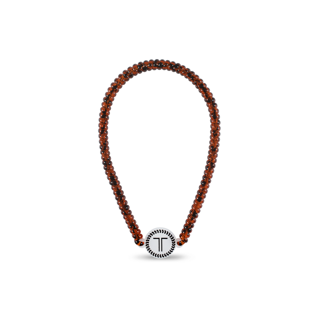 Beaded brown necklace with round white "T" pendant bordered in black. Available sizes: S, M, L.