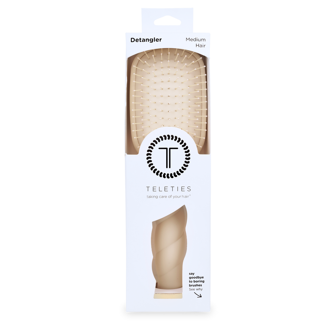 Tan Detangler Hair Brush for Medium Hair in white packaging labeled “Detangler” and “TELETIES,” with the tagline “taking care of your hair”; available in medium size.