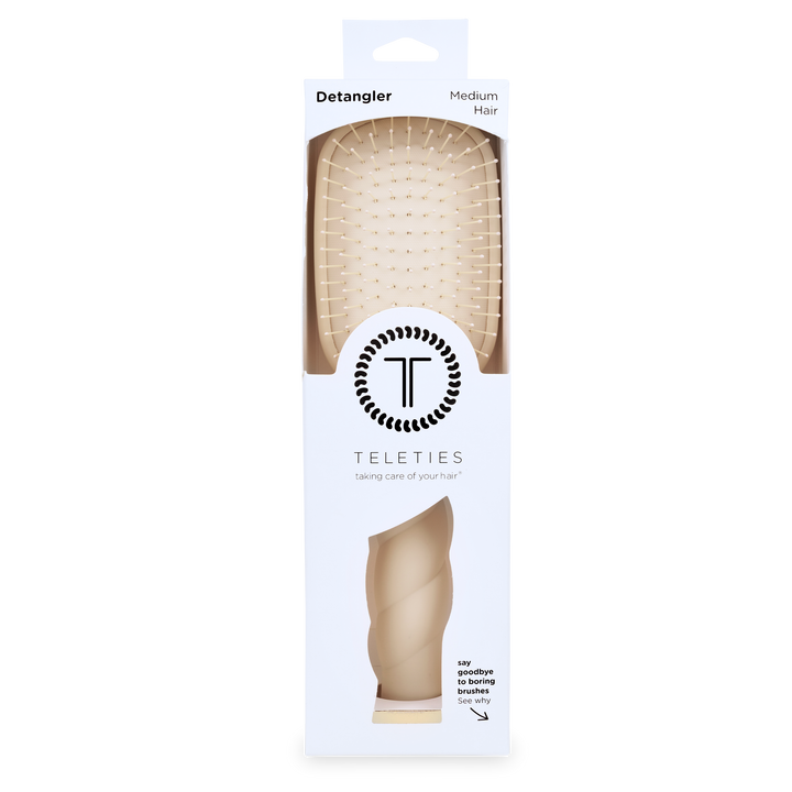 Tan Detangler Hair Brush for Medium Hair in white packaging labeled “Detangler” and “TELETIES,” with the tagline “taking care of your hair”; available in medium size.