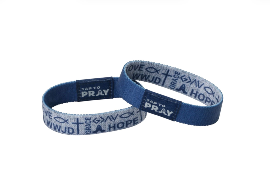 Two blue Tap To Pray™ wristbands featuring “TAP TO PRAY,” “WWJD,” “GRACE,” and “HOPE.” Available in multiple sizes.