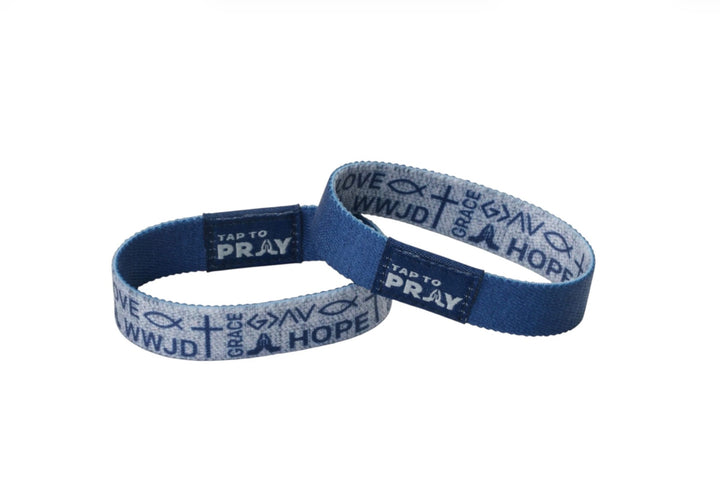Two blue Tap To Pray™ wristbands featuring “TAP TO PRAY,” “WWJD,” “GRACE,” and “HOPE.” Available in multiple sizes.