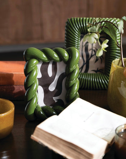 Two green photo frames, including the uniquely designed Green Resin Twisted Photo Frame. Available sizes: 4x6 and 5x7 inches.