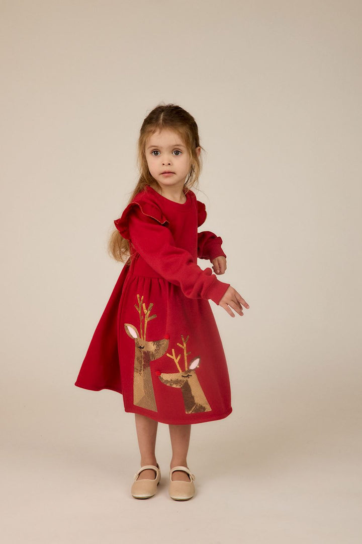 Red sequin reindeer ruffle dress with long sleeves, shoulder ruffles, and two sequined deer on the skirt. Available in sizes 2T-8.