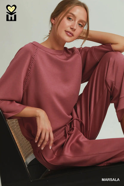 Relaxed-fit, rose-colored loungewear set with Butterfly Lace Straight Leg Pants and textured sleeve detailing. Sizes available: XS-XL.
