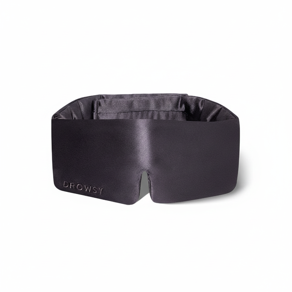 Black silk Drowsy Sleep Mask with "DROWSY" embroidery on one side. Available in standard and large sizes.
