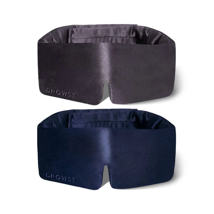 Two Drowsy Silk Sleep Masks in dark grey and navy, "DROWSY" embroidered. Available in standard and large sizes.