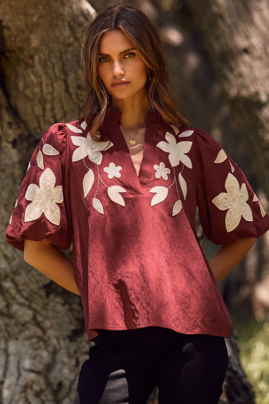Washed Suede Top in camel with white floral applique on the chest and puffed sleeves; available in sizes XS-XL.