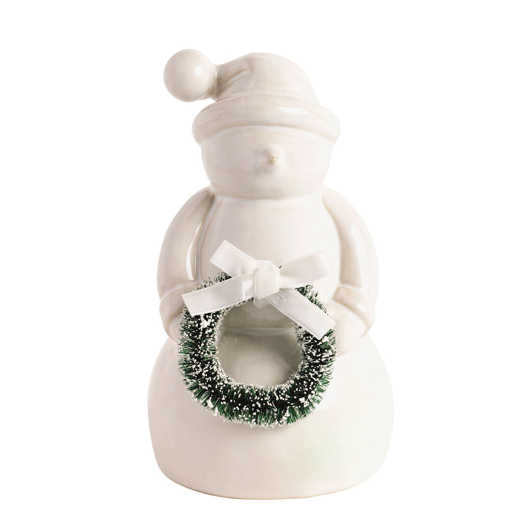 Ceramic snowman figurine holding a green wreath with a white bow.