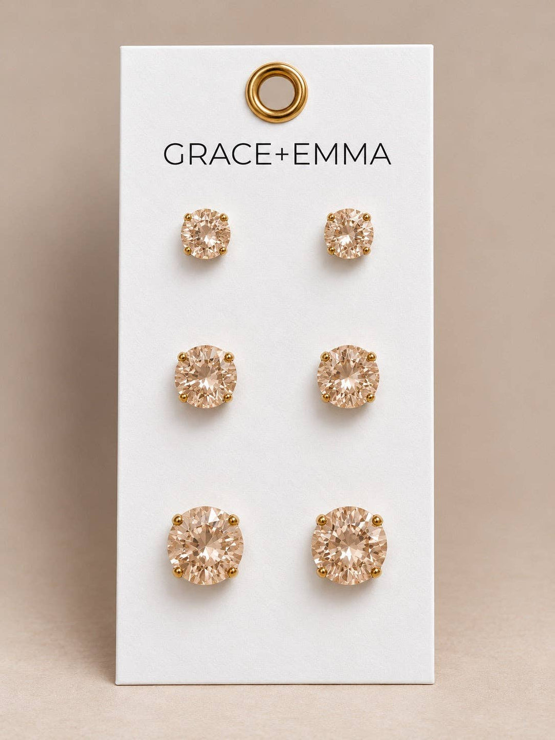 Three pairs of round-stone champagne stud earrings.