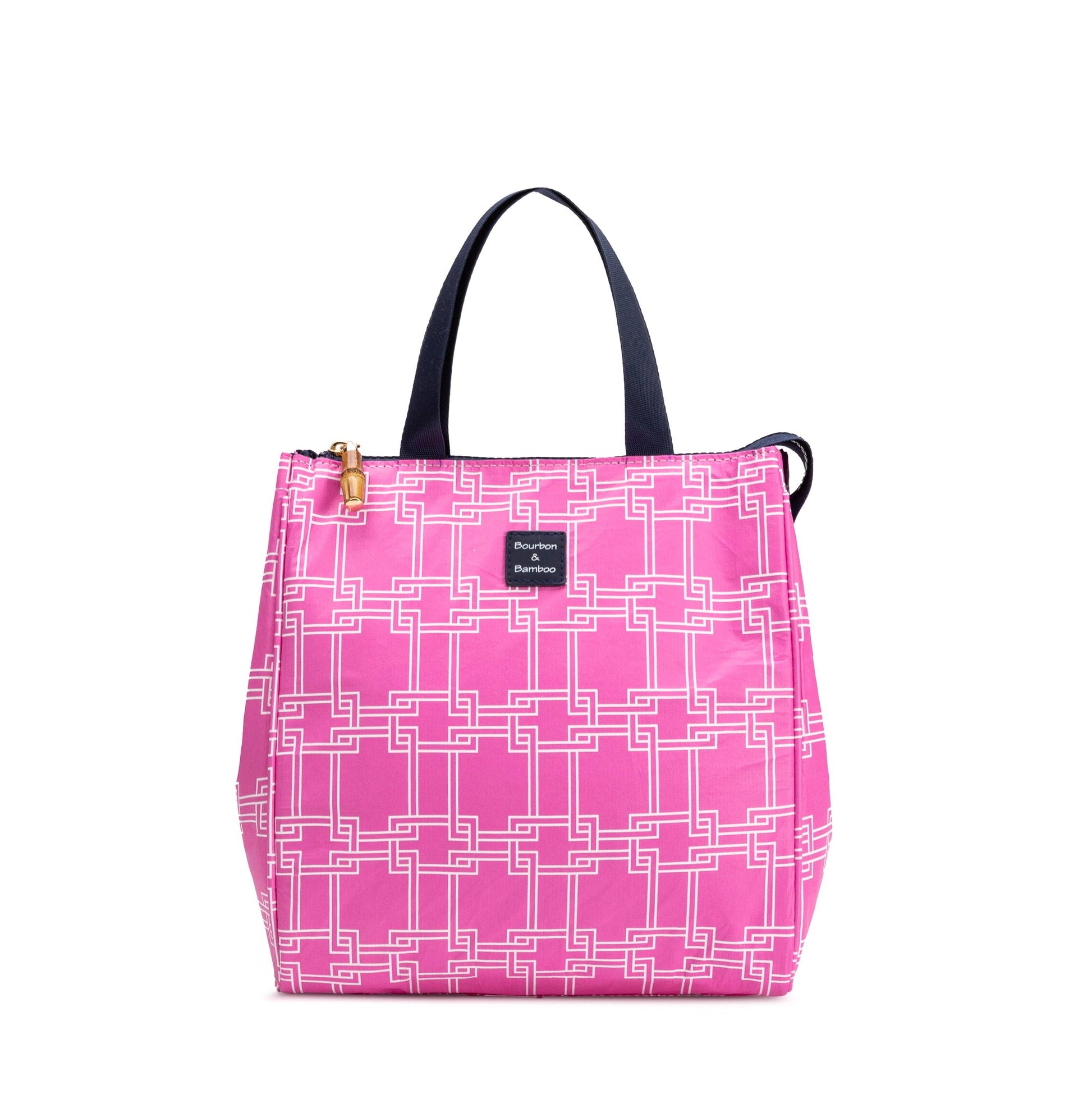 Pink tote with white geometric pattern, black handles, gold zipper, small front label; insulated. Sizes: small, medium, large.