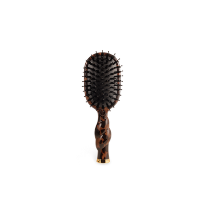 Mini boar bristle brush with brown and black tortoiseshell pattern and gold accent at handle base. Available in mini size.