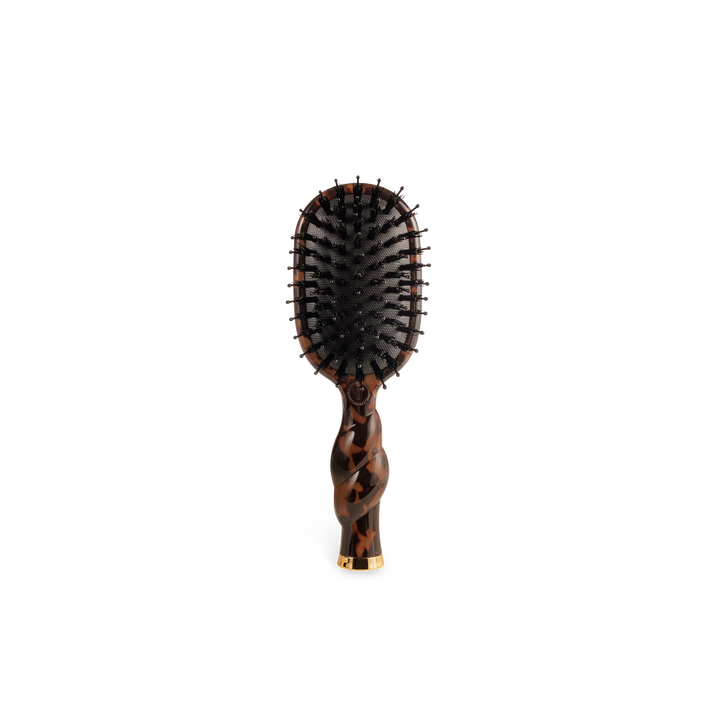 Mini boar bristle brush with brown and black tortoiseshell pattern and gold accent at handle base. Available in mini size.