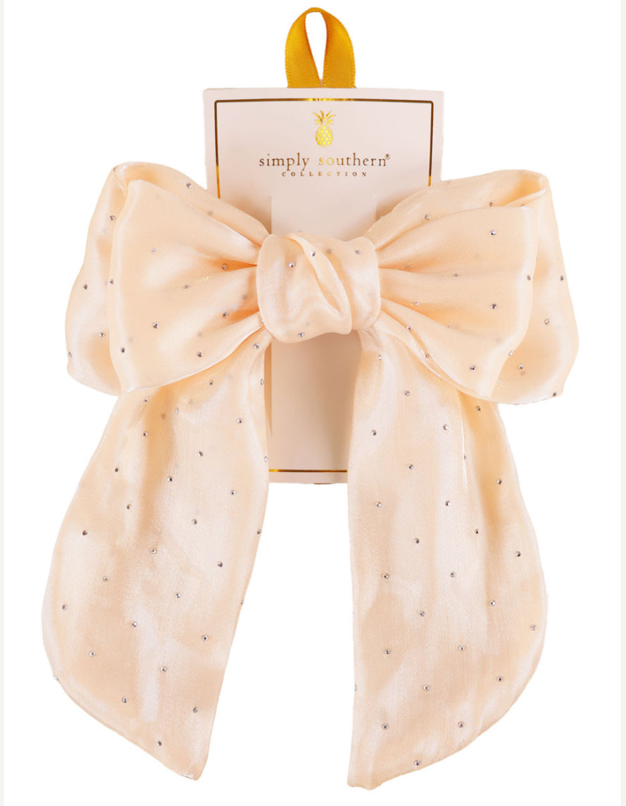 Large pale peach hair bow with small silver dots, yellow loop. Available in large size. Simply Southern brand.