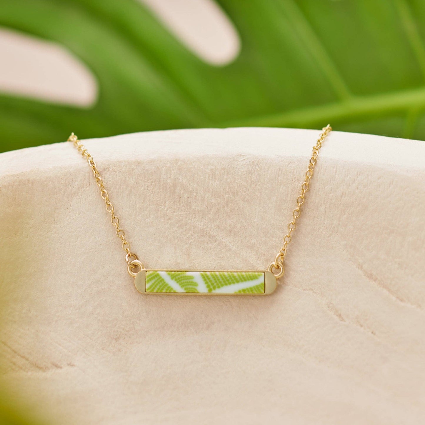 Seaside Green Reversible Mini Bar Necklace featuring a summer colors pendant with a green fern leaf design. Handcrafted with a delicate chain. Sizes: One size available.