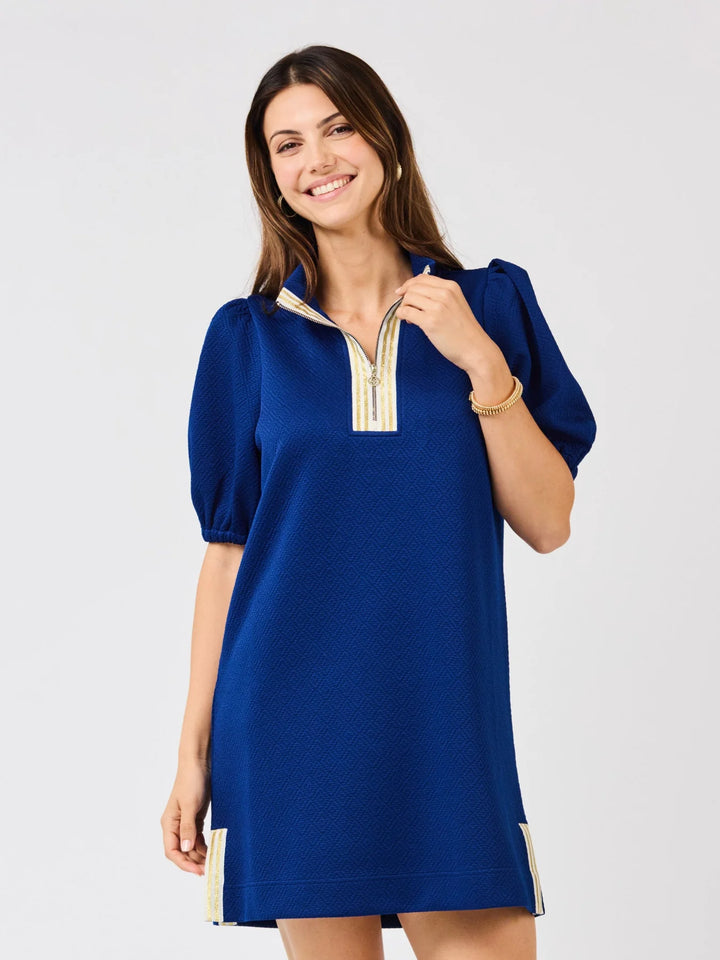 Andie Navy Dress with zippered V-neck and gold accents. Available in sizes XS-XL.