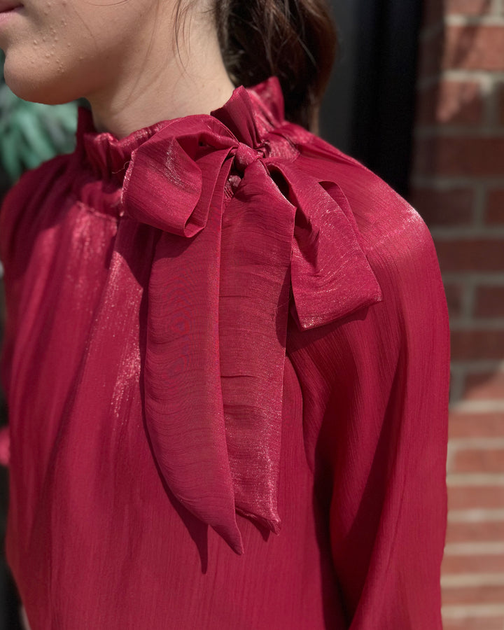 Ruffle Neck Adjustable Tie Long Sleeve Blouse in shiny red, available in sizes XS-XL.