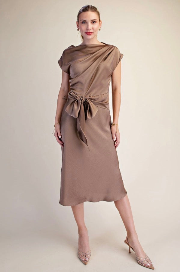 Taupe satin midi dress with short sleeves and a large asymmetrical tie detail at the waist. Available in sizes XS–XL.