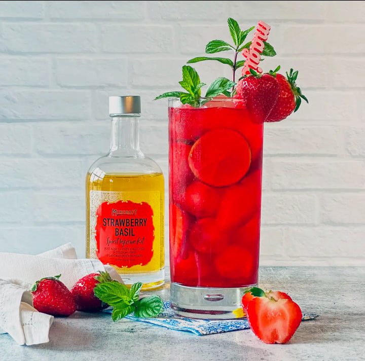 All-natural Spirit InFusion Kit in “Strawberry Basil,” available in 16oz and 32oz sizes, with bright red cocktail.