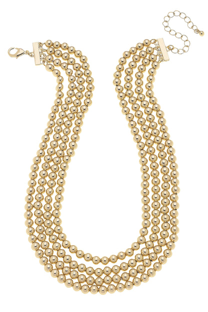 The Saint 4-Row Layered Ball Bead Necklace in Shiny Gold with adjustable clasp; available in one size.