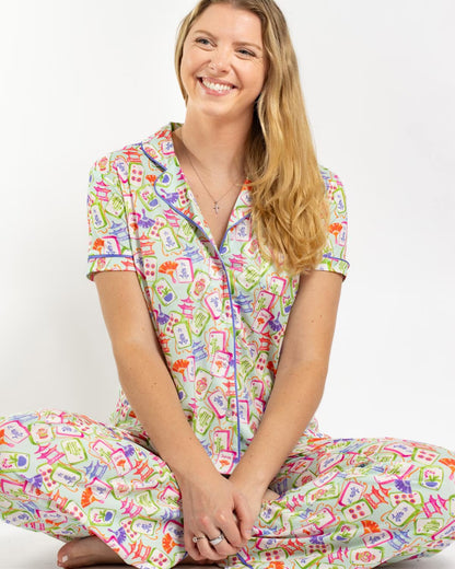 Mahjong Dreams Short Sleeve & Pants pajama set with vibrant patterns of shapes and words on a white background, available in sizes XS-XL.