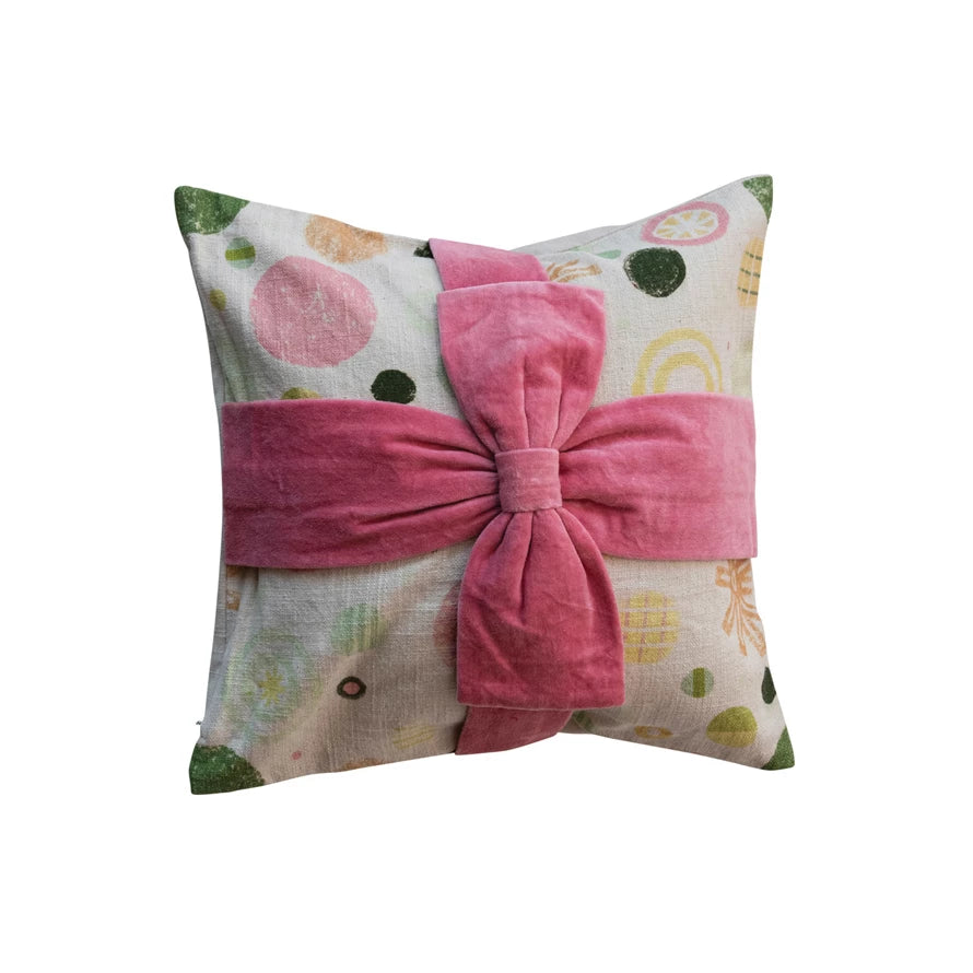 16 in. cotton pillow with green, yellow, pink circles on pastel abstract print; large pink velvet appliqué bow at center.