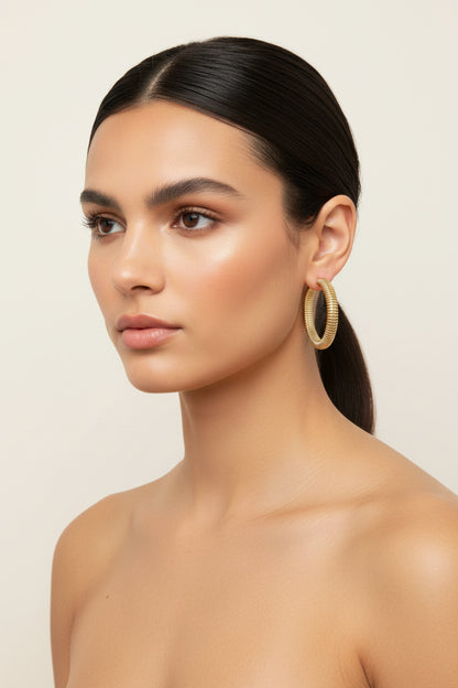 Hoop Earrings in a polished finish, available in small, medium, and large sizes.