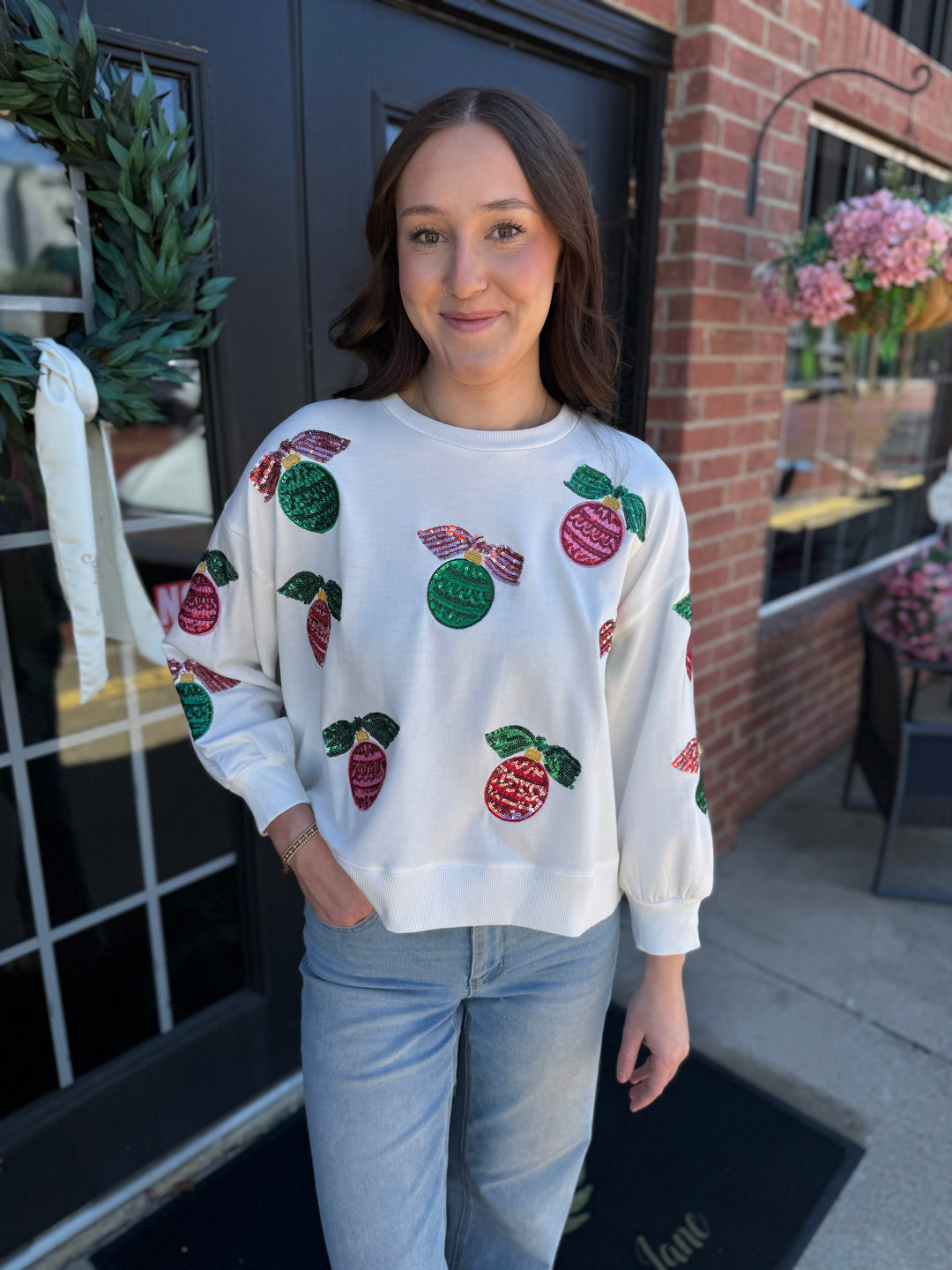 White Millie Baubles & Bows Sweatshirt with sequined red and green ornaments. Sizes available.