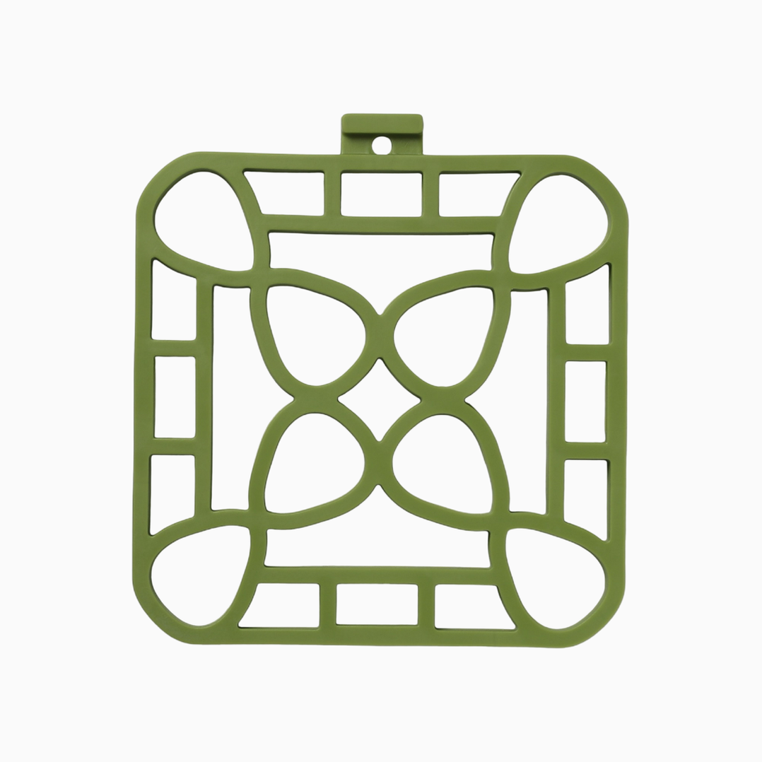 Green square silicone trivet with geometric cut-out, small hanging loop; available in multiple sizes; heat-resistant.
