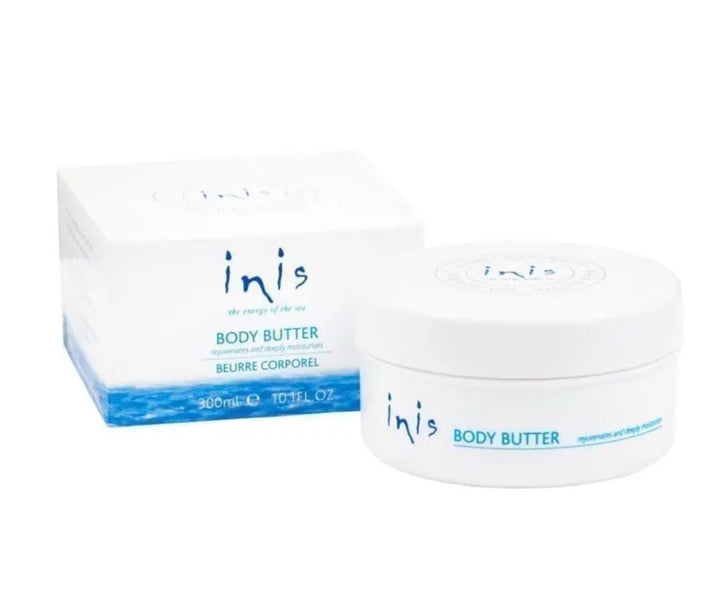White circular container labeled "Inis Fragrances of Ireland," paired with a matching rectangular box. Both items display blue text and ocean-themed graphics at the bottom, suggesting a fresh unisex fragrance. Size: 300 ml or 10 FL. OZ.