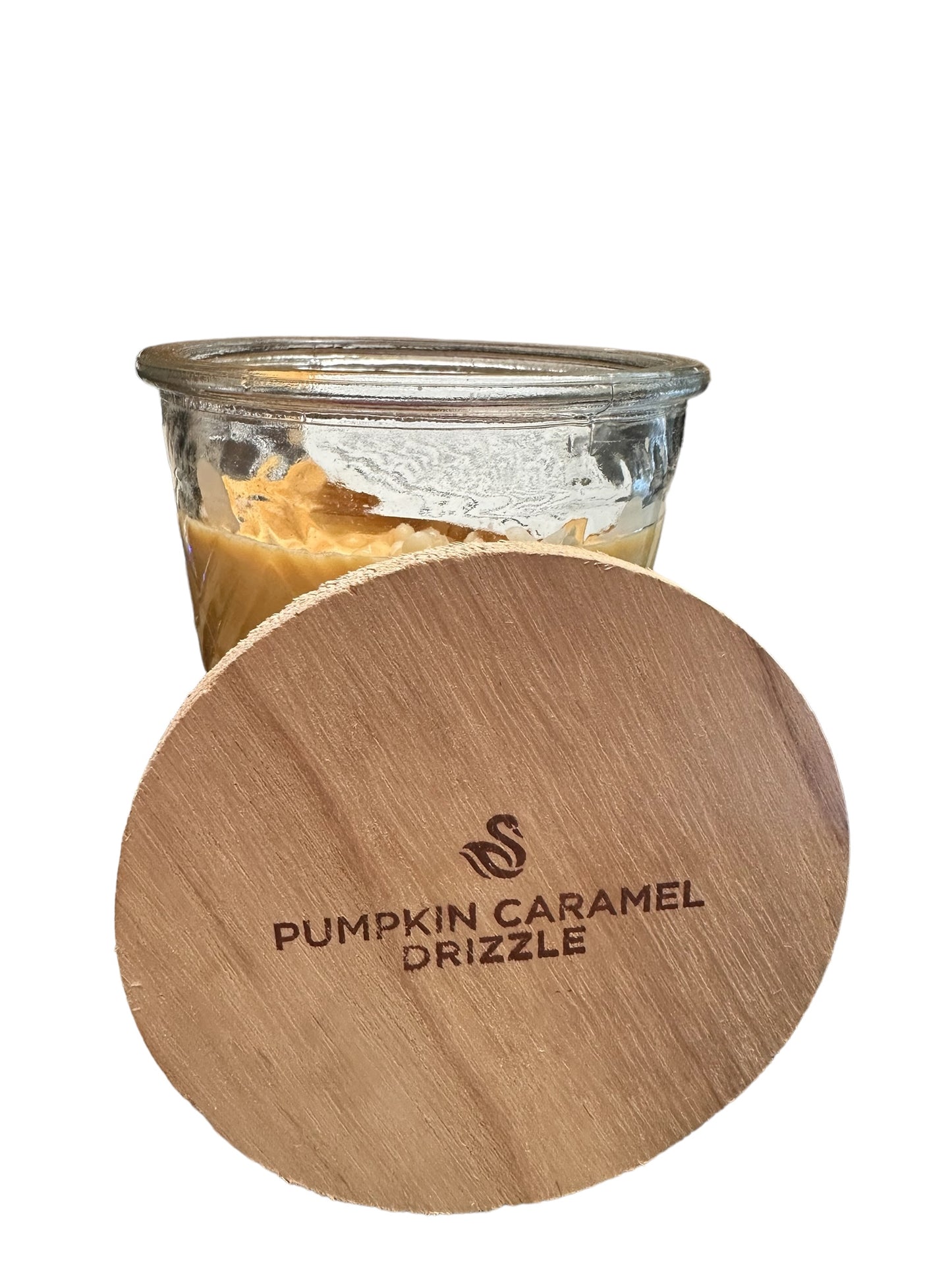 A glass jar labeled "Pumpkin Caramel Drizzle Candle" with a wooden lid, containing orange-brown soybean wax for a long-lasting burn. Available in sizes: small, medium, and large.