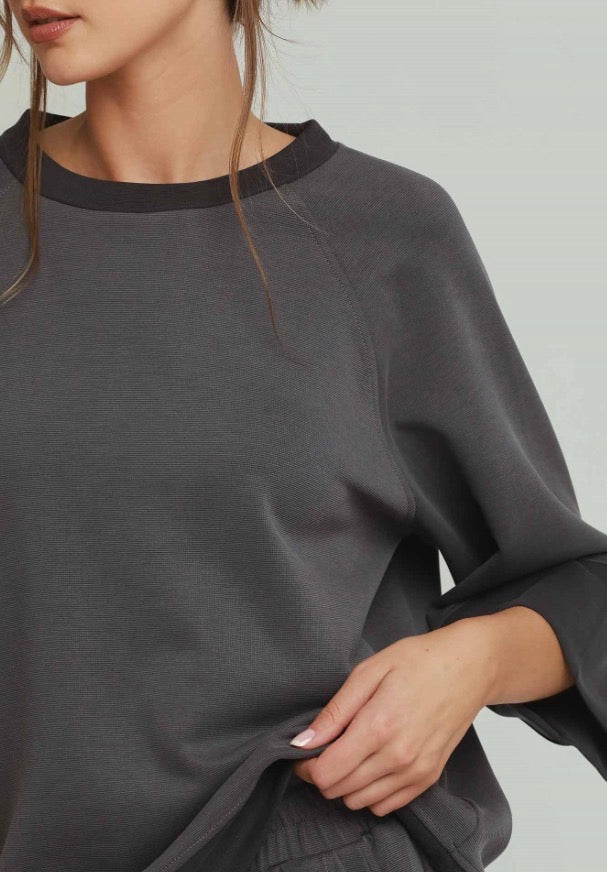 Charcoal colorblock raglan top in charcoal-gray ultra-soft fabric with a dark-gray crew neckline and raglan sleeves.