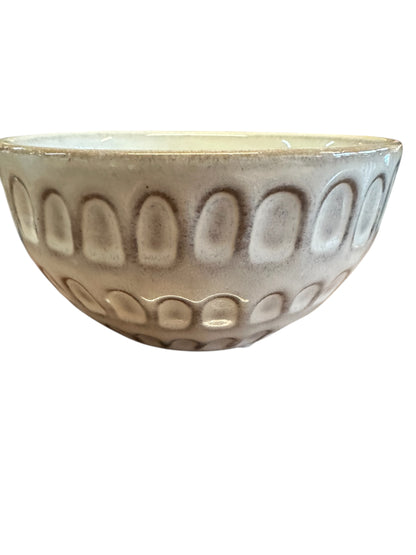 Handcrafted light beige stoneware bowl with embossed oval pattern; available in 4 styles and sizes.