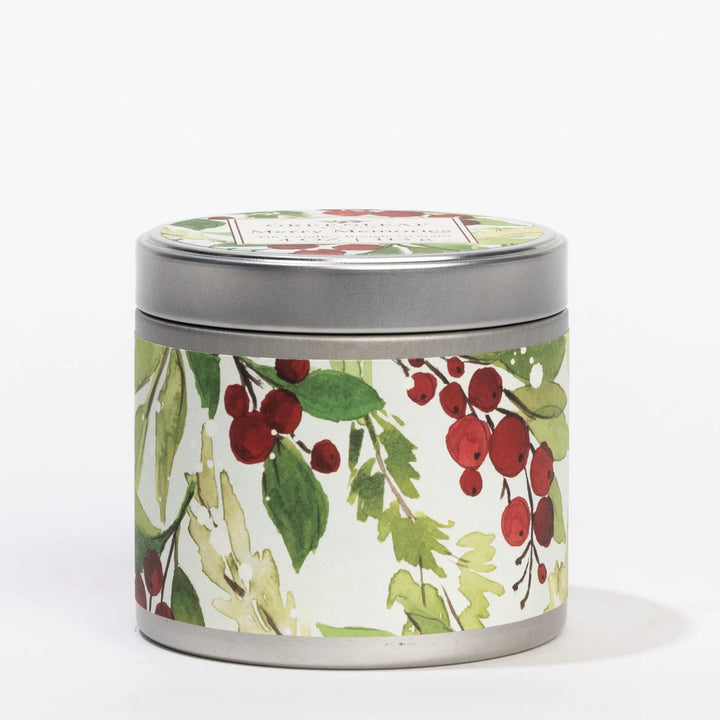 Merry Memories 4oz tin candle with green leaf and red berry print, scented with ginger, cinnamon, and vanilla.