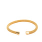 The Cuff Paris is a gold, open-ended mesh bracelet with smooth cylindrical caps on both ends. Available in S, M, and L.