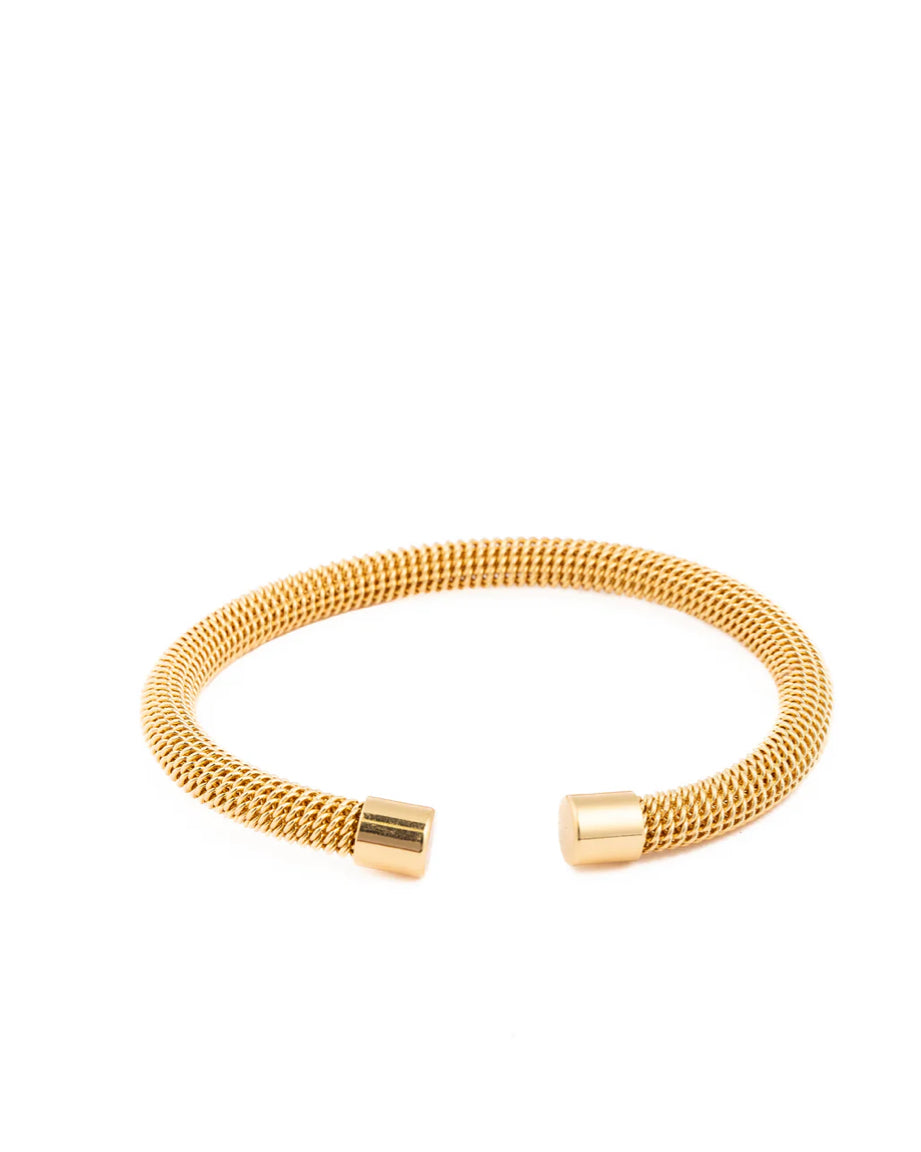 The Cuff Paris is a gold, open-ended mesh bracelet with smooth cylindrical caps on both ends. Available in S, M, and L.