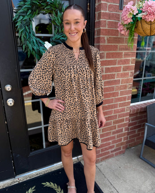 Audrey Leopard Print Smocked Dress featuring a smocked bodice and leopard pattern. Available in sizes XS-XL.