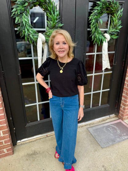 Haley Black Top with embroidered eyelet sleeves; available in sizes XS-XL.