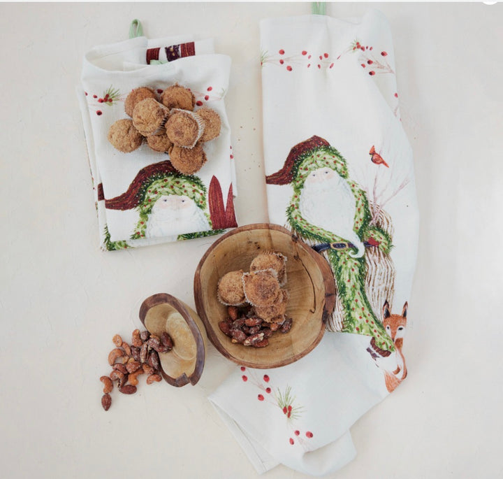 Two cotton printed tea towels featuring a festive Santa in a green coat and red berries.