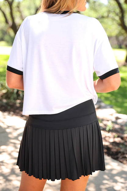 After Dark Pleated Tennis Skort in black, featuring pleated design. Available in sizes XS-XL.