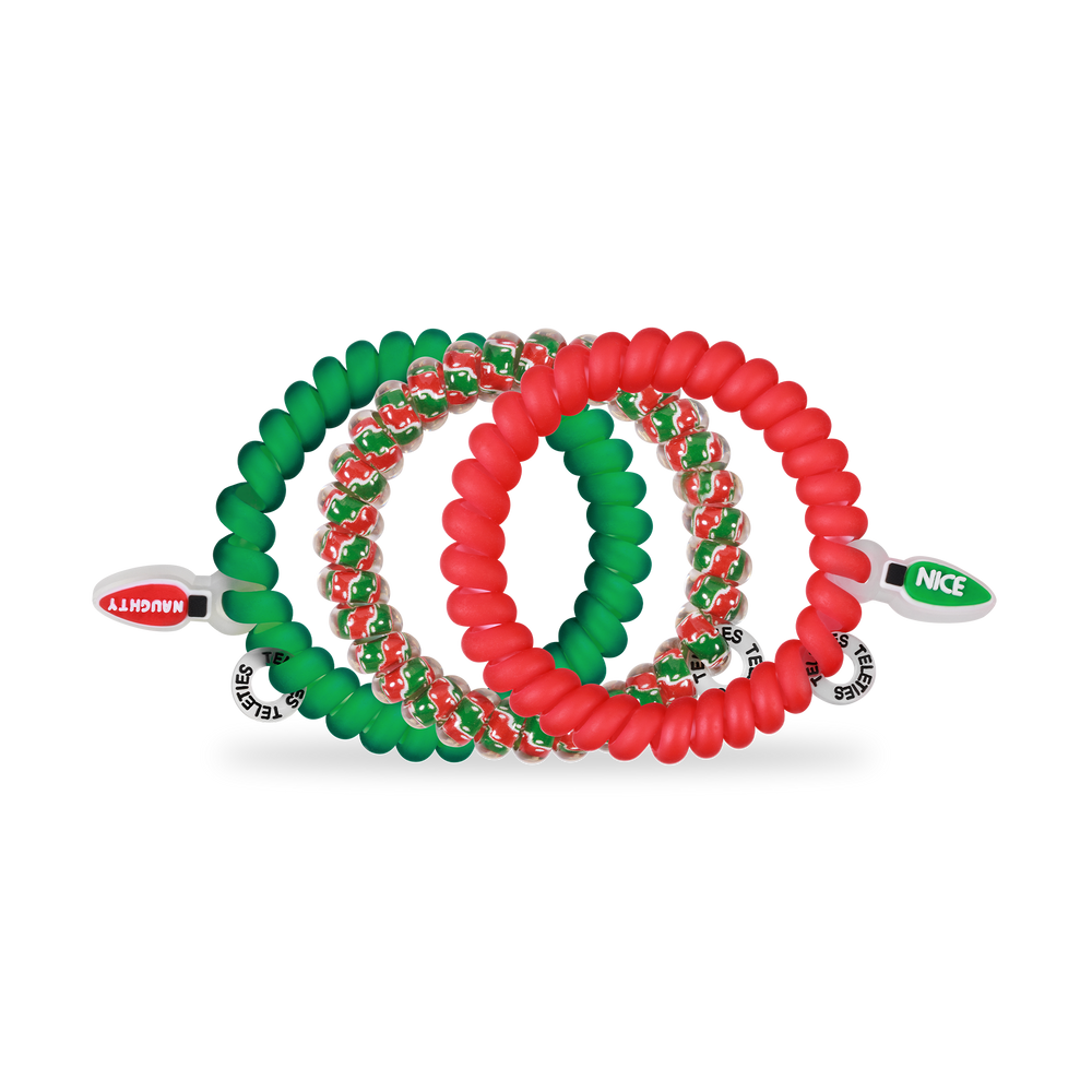 Small spiral hair coil set: one green "NAUGHTY" tie, one red "NICE" tie, both with festive beads; no-damage hold.