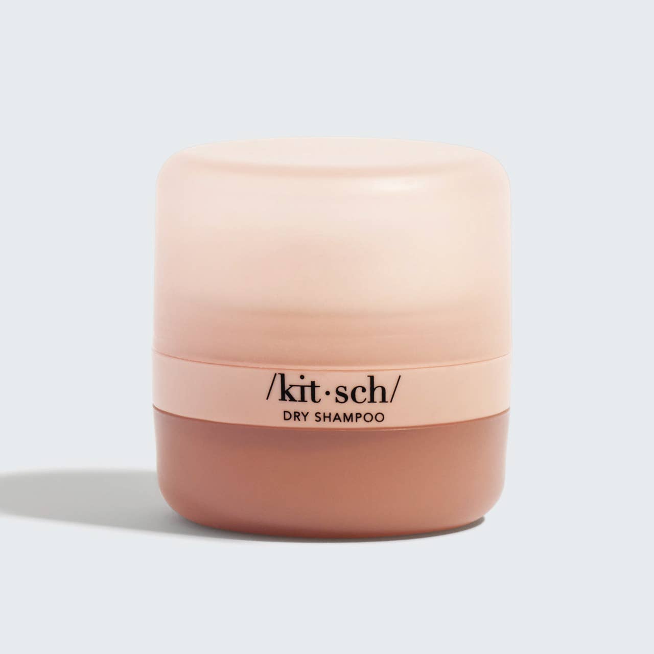 Small, rounded Volumizing Rice Protein Dry Shampoo, gradient pink-beige design, bold black text. Available in multiple sizes.